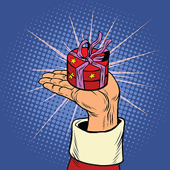 Image showing Hand of Santa Claus with round gift box