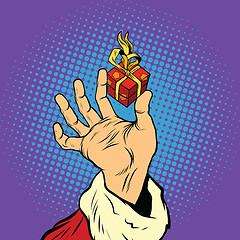 Image showing Hand of Santa Claus and a small gift