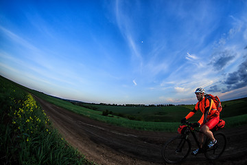 Image showing Mountain bikeer rides on the trail against beautiful sunset