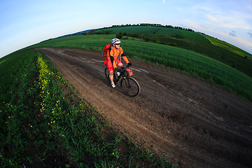 Image showing Mountain bikeer rides on the trail against beautiful sunset