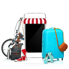 Image showing The blue suitcase, sneakers, clothing, hat, and phone on white background.