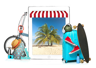 Image showing The blue suitcase, sneakers, clothing, hat, and laotop on white background. The travel, tourism  holidays concept