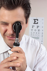 Image showing Eye doctor using opthalmoscope