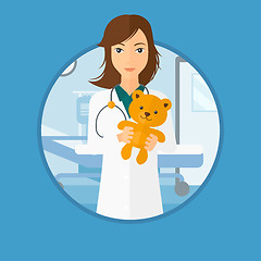 Image showing Pediatrician doctor holding teddy bear.