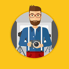 Image showing Photographer with camera in photo studio.