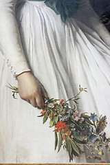 Image showing some flowers in the hand of a woman in a white dress