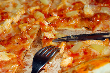 Image showing appetizing pizza cut by knife and fork