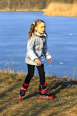 Image showing young girl goes in roller skates on the ground