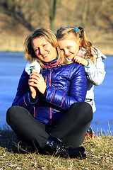 Image showing mother and her daughter embrace and smile