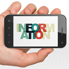 Image showing Information concept: Hand Holding Smartphone with Information on  display