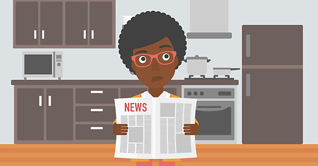 Image showing Woman reading newspaper.