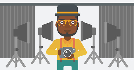 Image showing Smiling photographer holding camera.