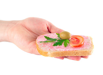 Image showing hand holding toast with fish caviar cream