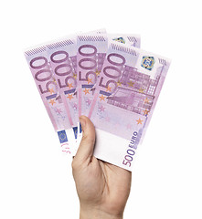 Image showing Male hand holding four 500 euro notes isolated