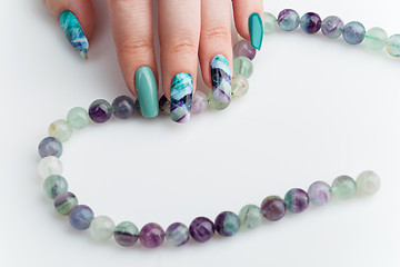 Image showing Closeup of woman hand with colorful nails