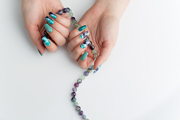 Image showing Closeup of woman hands with colorful nails