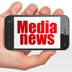 Image showing News concept: Hand Holding Smartphone with Media News on display