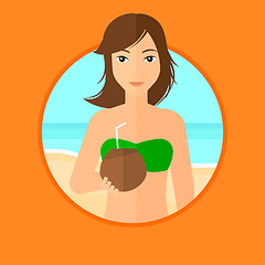 Image showing Woman drinking coconut cocktail on the beach.