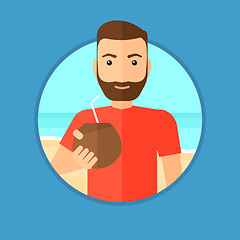 Image showing Man drinking coconut cocktail on the beach.