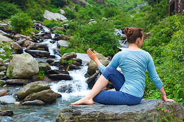 Image showing Woman doing Ardha matsyendrasana asana outdoors