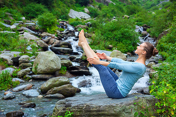 Image showing Woman doing Ashtanga Vinyasa Yoga asana Navasana outdoors