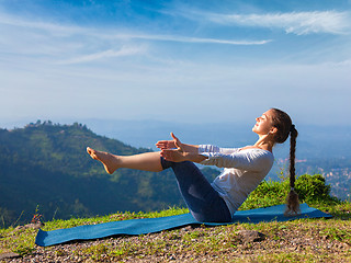 Image showing Woman doing Ashtanga Vinyasa Yoga asana Navasana - boat pose