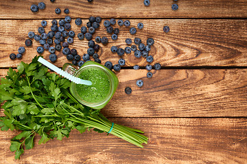 Image showing Mug with green smoothie drink and bundle of fresh parsley