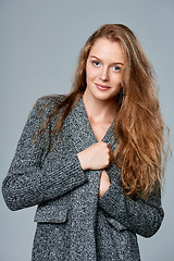 Image showing Woman muffling in warm knitted cardigan