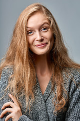 Image showing Happy laughing woman in warm knitted cardigan