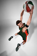 Image showing Full length portrait of a basketball player with ball