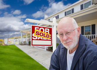 Image showing Senior Adult Man in Front of Real Estate Sign, House