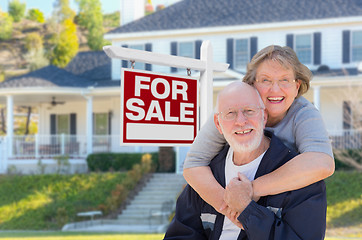 Image showing Senior Adult Couple in Front of Real Estate Sign, House