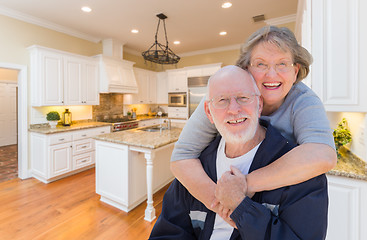 Image showing Senior Couple Hugging Inside Custom Kitchen