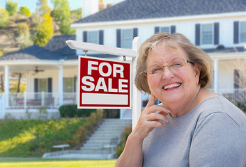 Image showing Senior Adult Woman in Front of Real Estate Sign, House