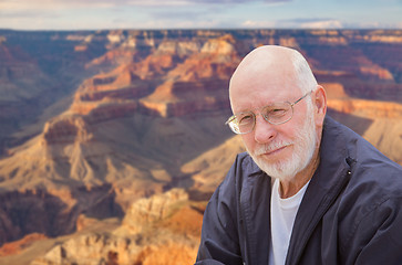 Image showing Happy Senior Man Posing on Edge of The Grand Canyon