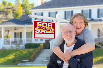 Image showing Senior Adult Couple in Front of Real Estate Sign, House