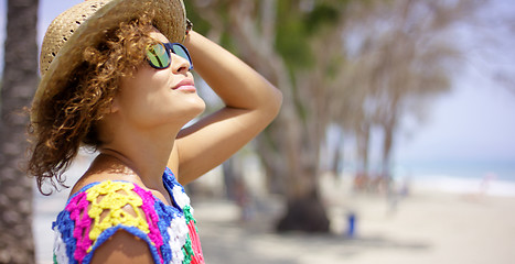 Image showing Woman in sunglasses and hat outside looking up