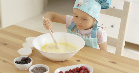 Image showing Adorable toddler at mixing bowl