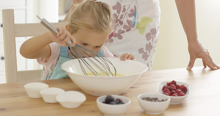 Image showing Little girl baking with her mother