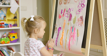 Image showing Artistic little girl painting a creative design