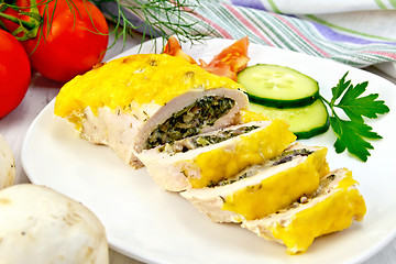 Image showing Roll chicken with mushrooms and cucumber on board