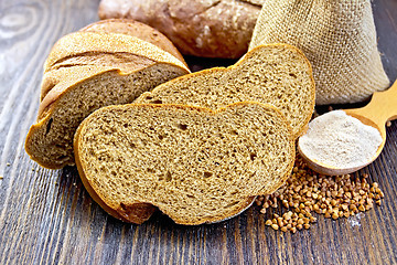 Image showing Bread buckwheat with cereals and flour in spoon on board