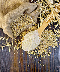 Image showing Flour oat in wooden spoon with bag on board top