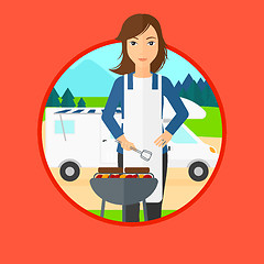 Image showing Woman having barbecue in front of camper van.