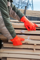 Image showing Carpenter working at sawmill