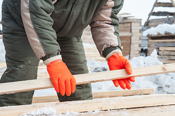 Image showing Carpenter working at sawmill