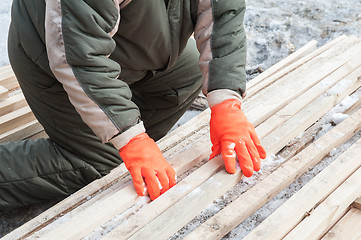 Image showing Carpenter working at sawmill