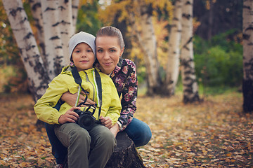 Image showing Woman and her son with camera