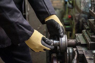 Image showing worker in protective gloves