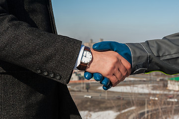 Image showing worker shakes hands with businessman